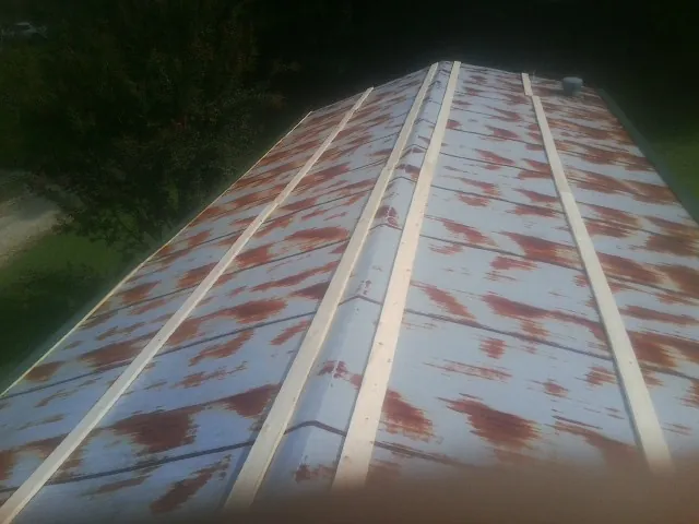 Rusted metal roof panels with new wood purlins before replacement — Storm Damage Roof Repair in King George by Roofing Brothers
